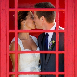 Wedding Couple in red phone booth by Traverse City Wedding Photographer Thomas Kachadurian