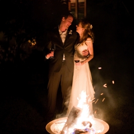 Bride and Groom by a wedding bonfire by Traverse City Wedding Photographer Thomas Kachadurian